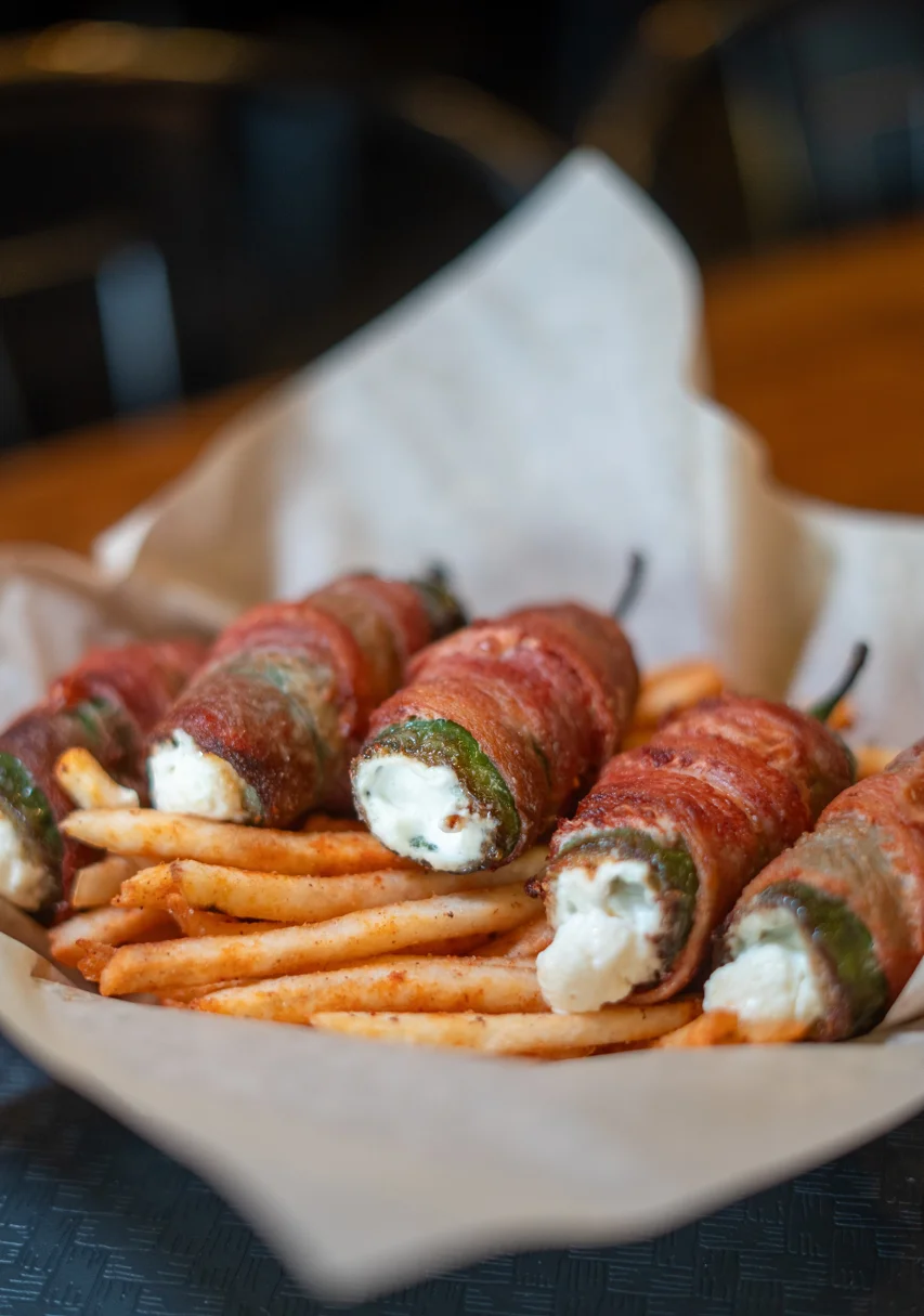 Bacon-wrapped jalapeño poppers with fries