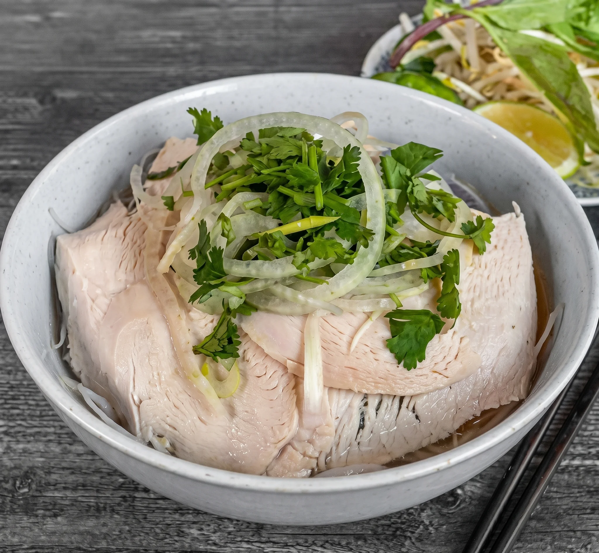 Vietnamese chicken pho garnished with herbs