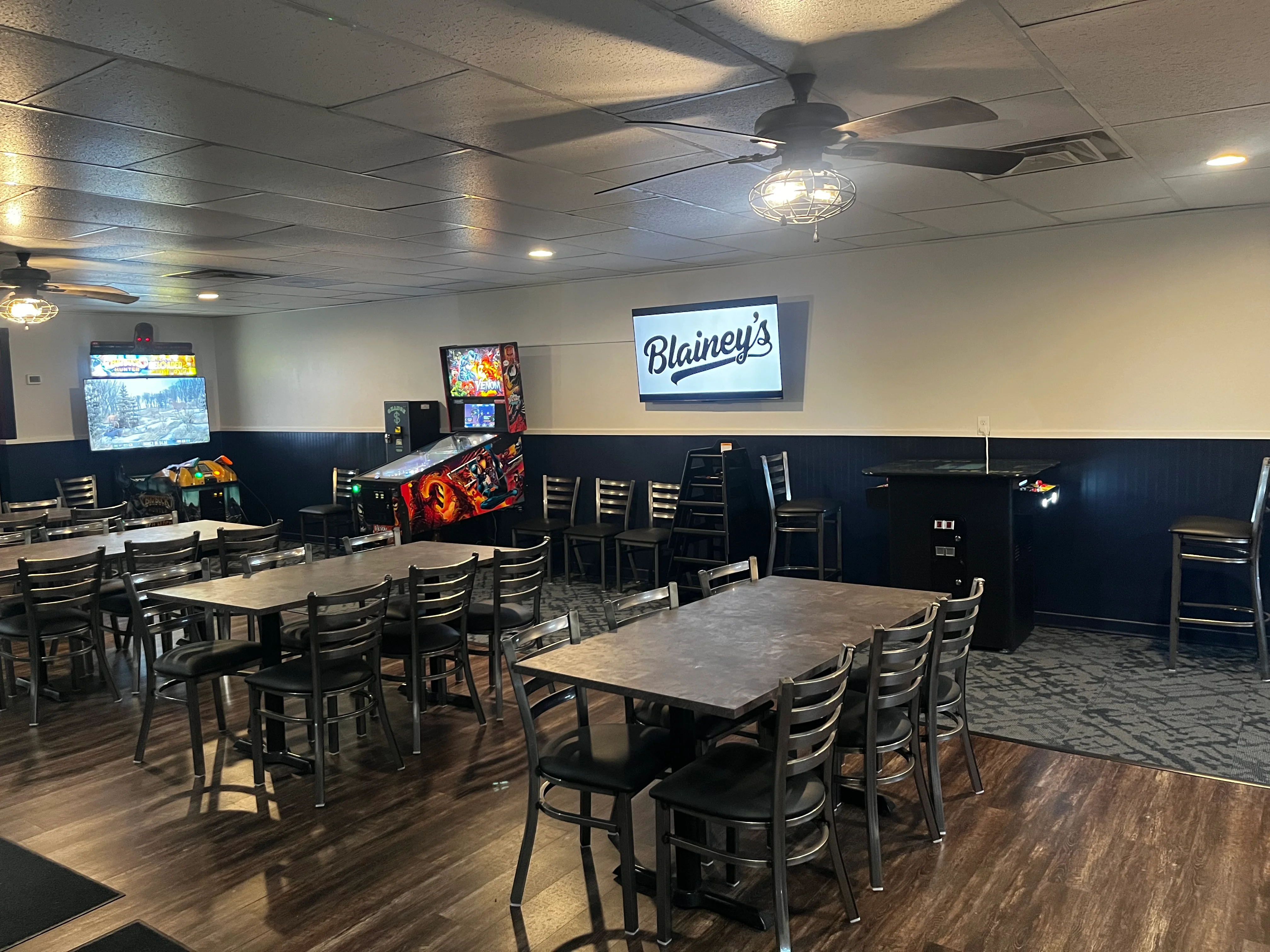 Cozy restaurant interior with gaming machines and tables