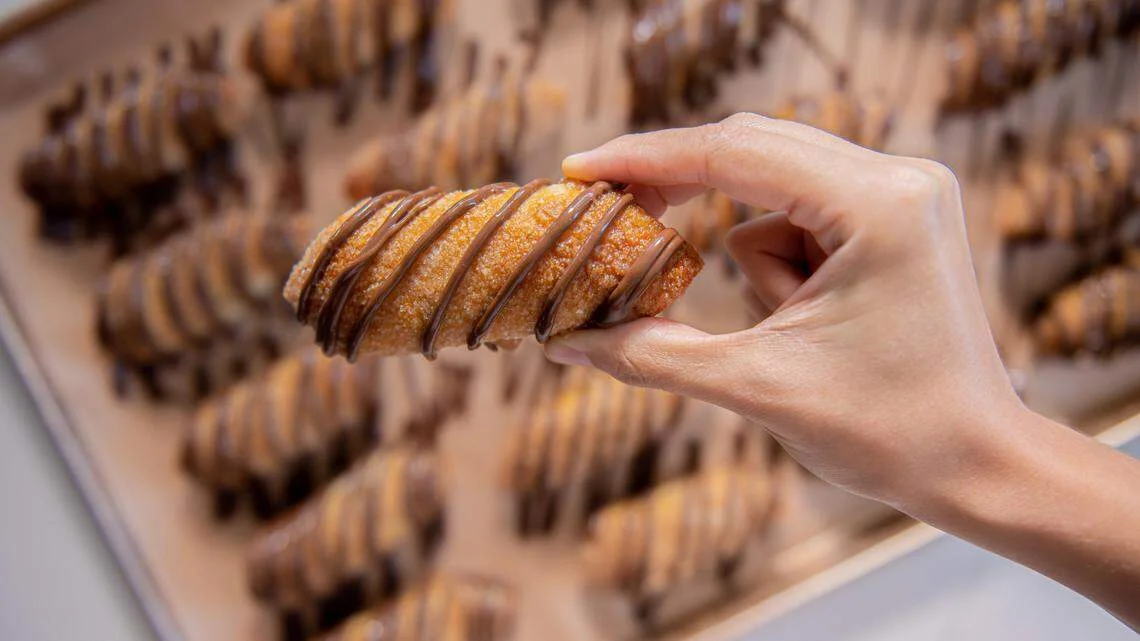 Delicious churros drizzled with chocolate sauce