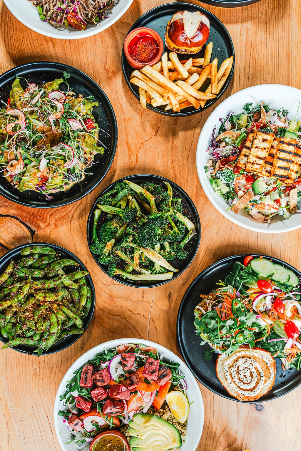 Colorful assortment of fresh salads and sides in a vibrant restaurant setting