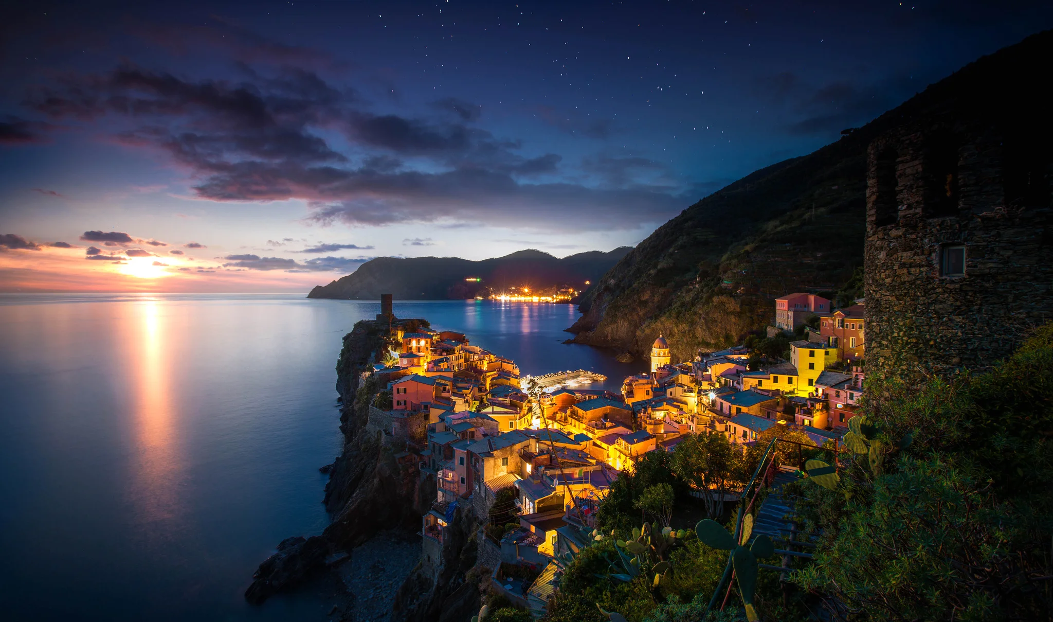 Scenic coastal village at dusk with colorful buildings and calm waters