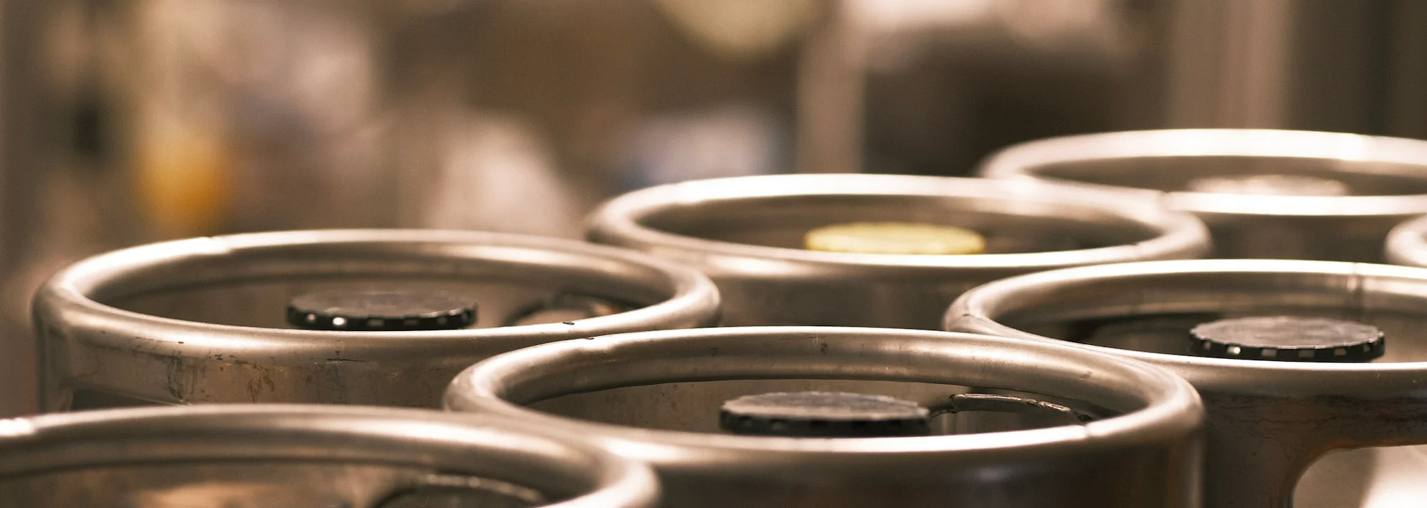 Close-up of stainless steel kegs in a brewery