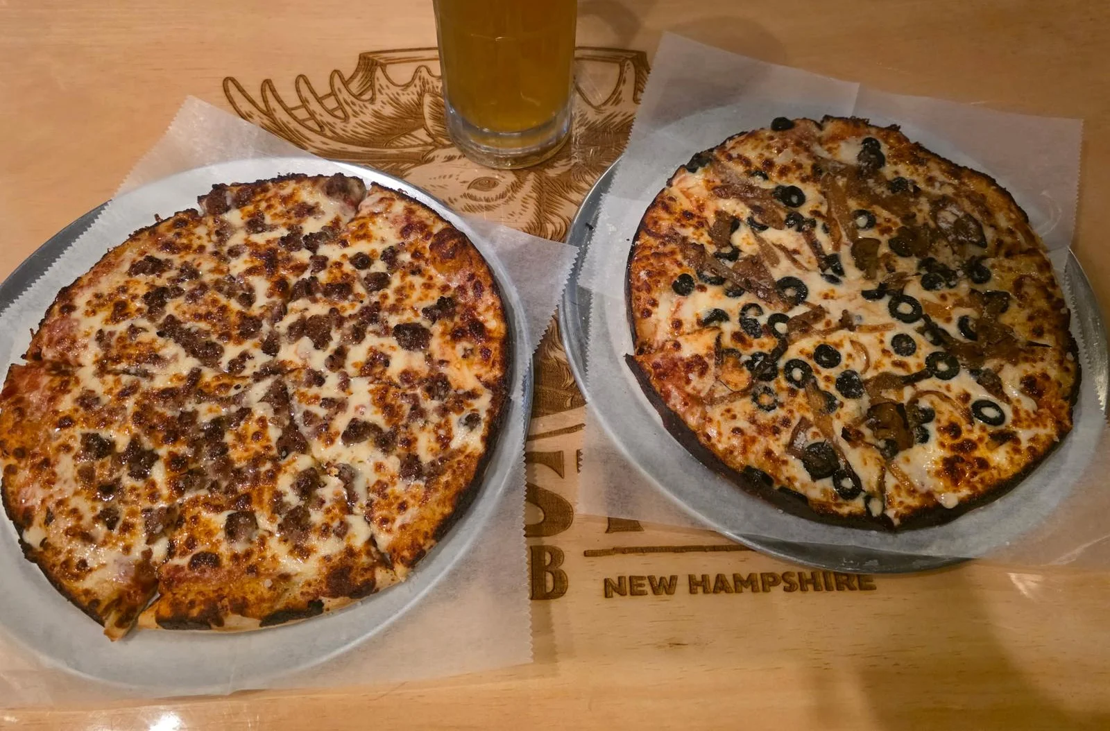 Two pizzas: classic meat and black olive specialty