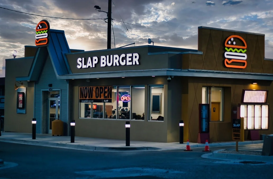Modern burger restaurant exterior with neon signage
