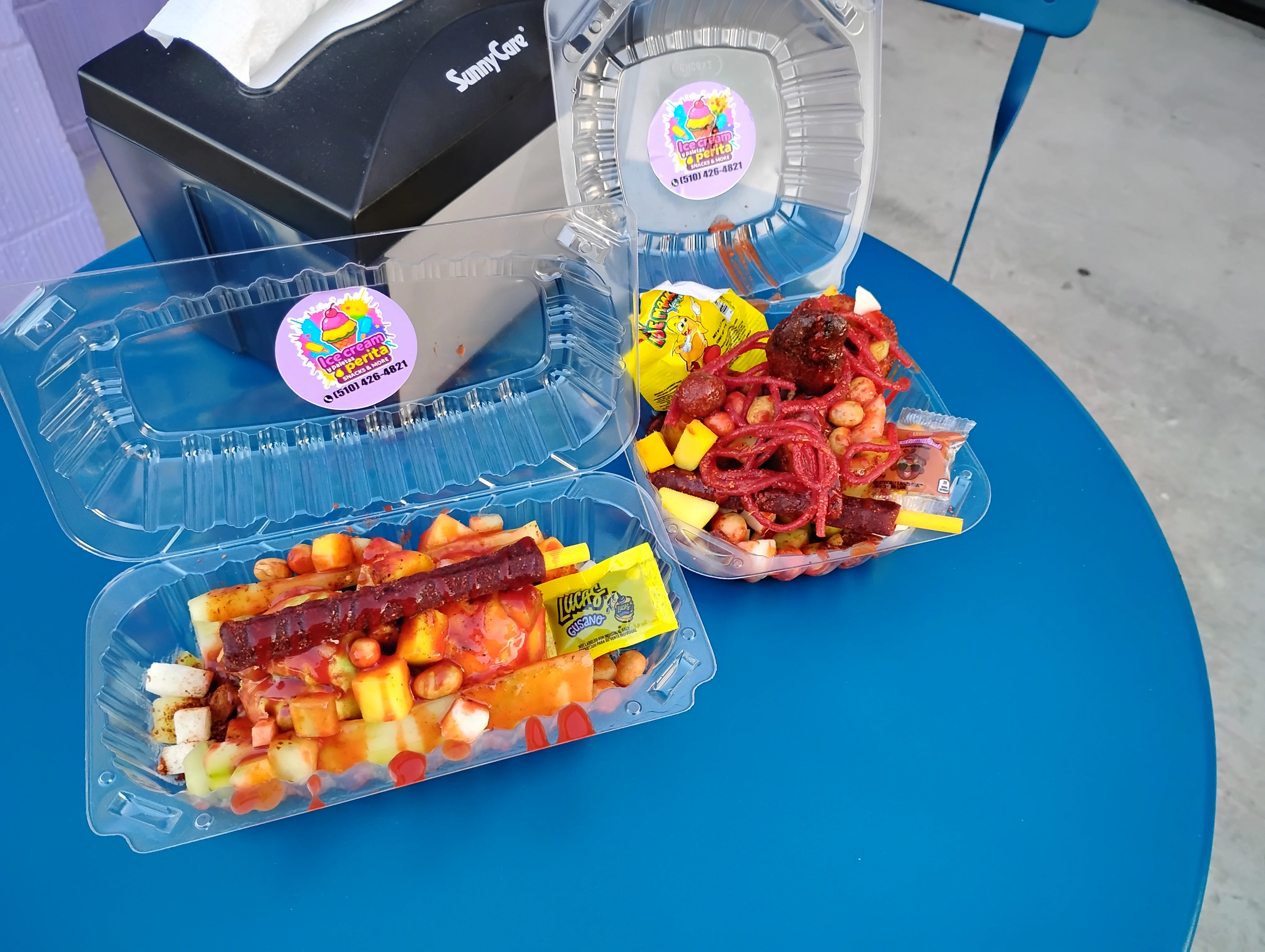 Colorful Mexican fruit and candy snack in clear containers