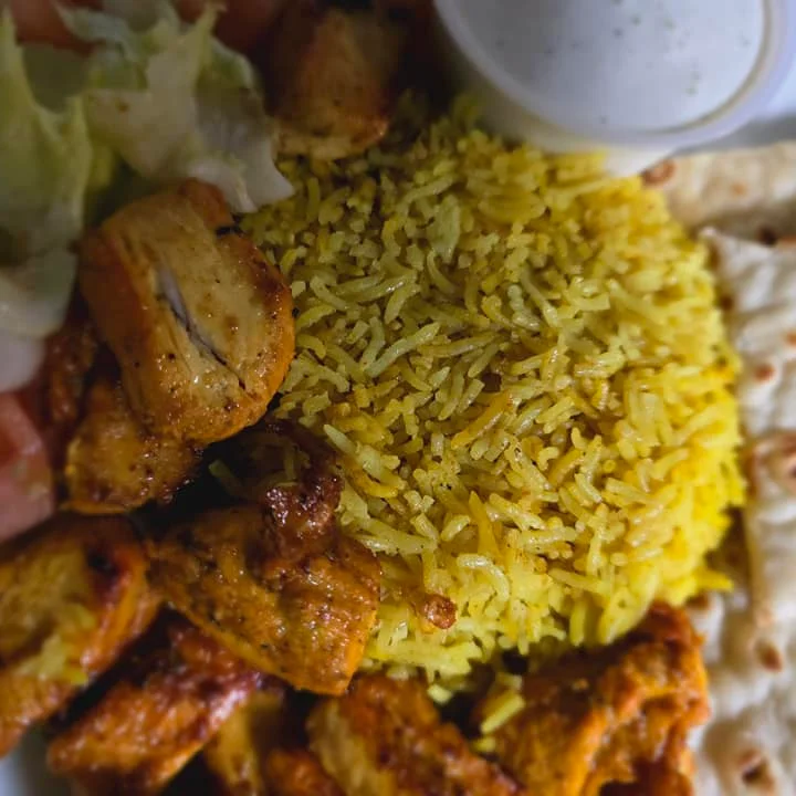 Grilled chicken biryani with naan and fresh salad