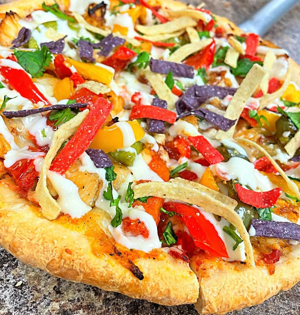 Colorful Mexican-style pizza topped with fresh vegetables