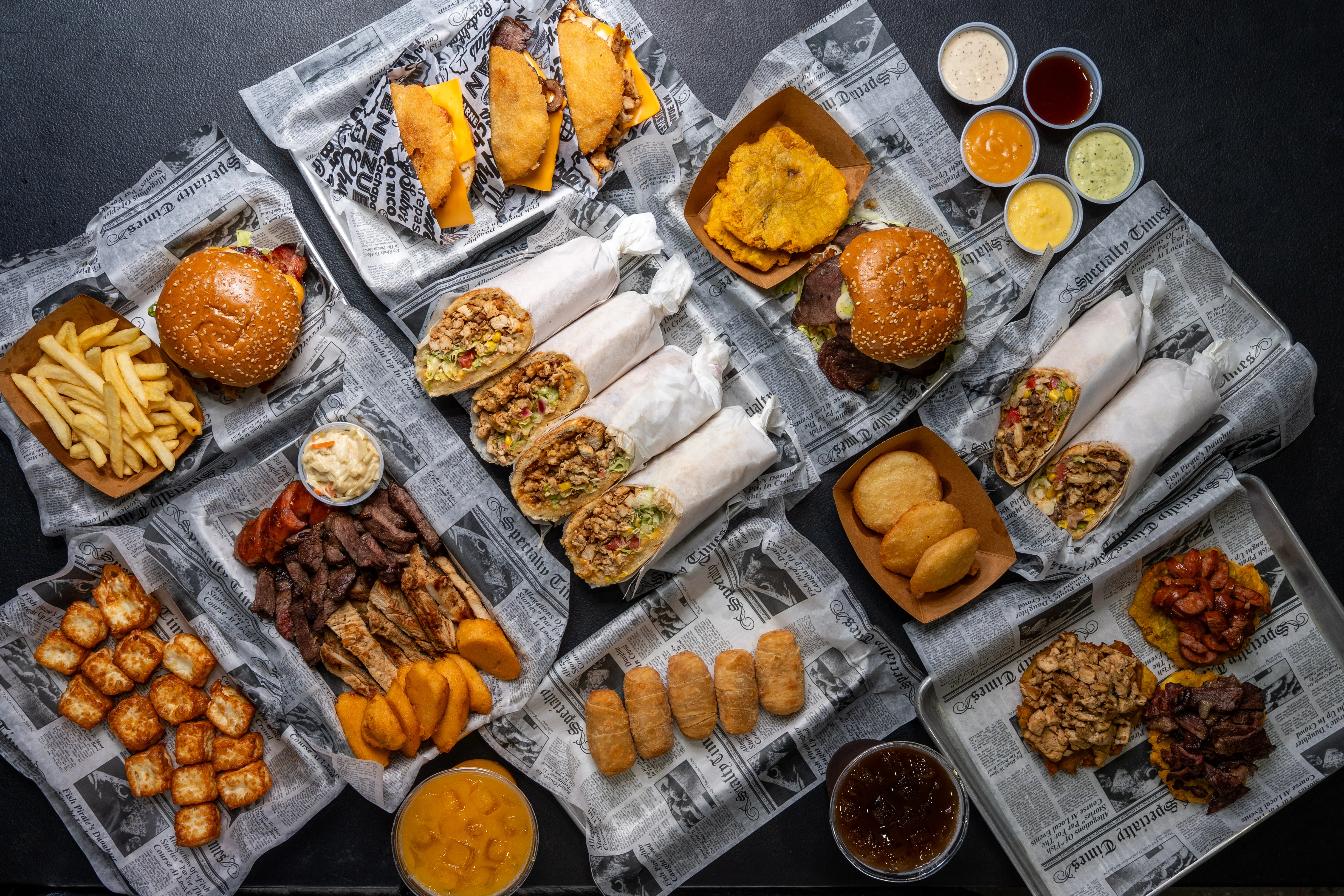 Variety of Latin American dishes including burritos and tostones