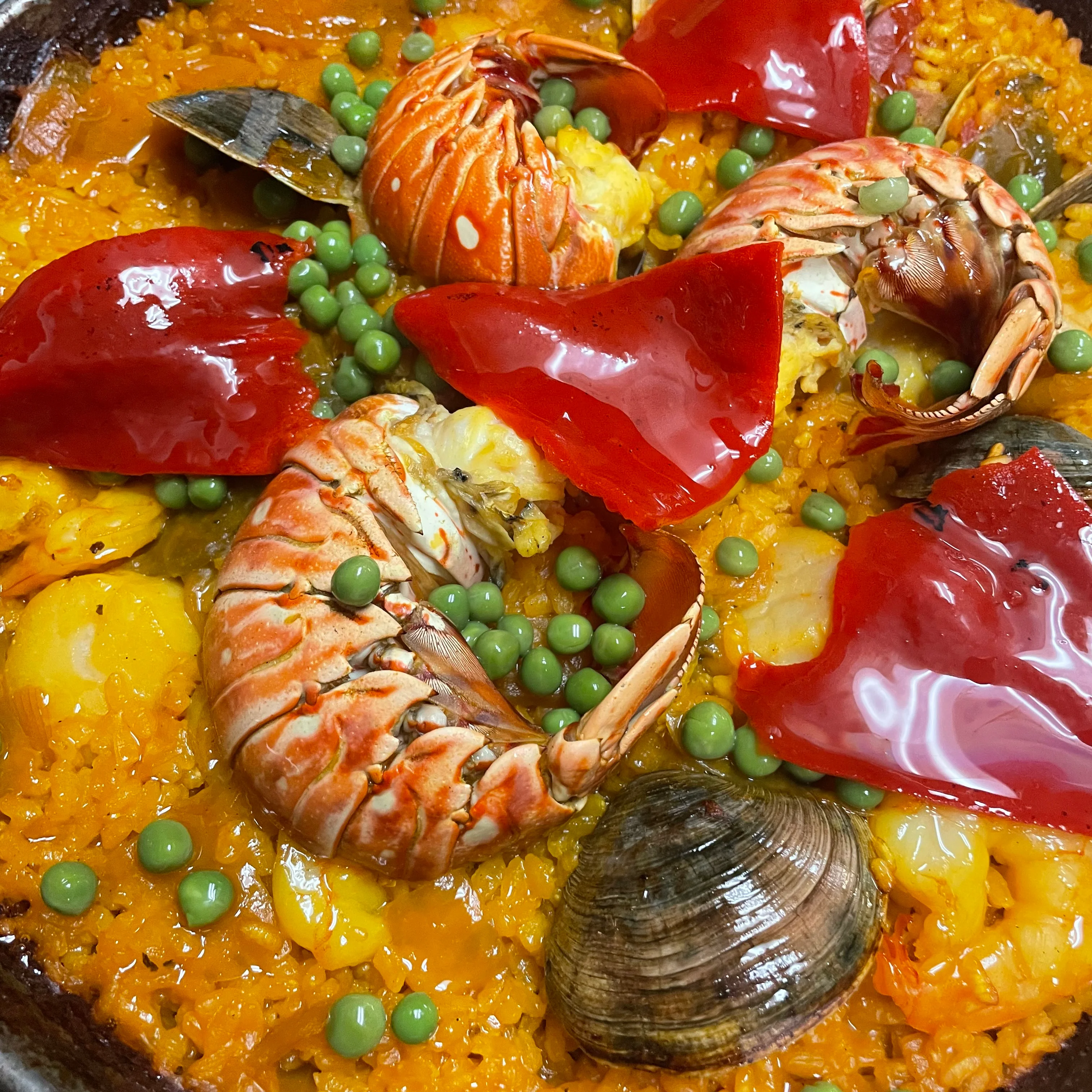 Vibrant seafood paella with lobster and peas