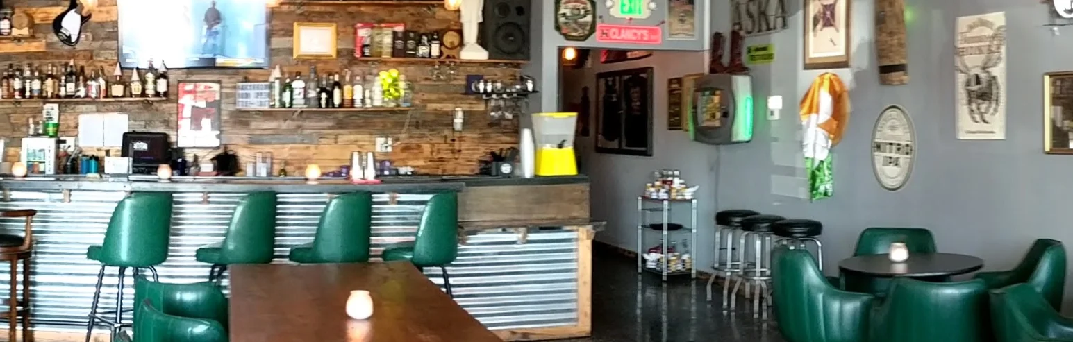 Cozy restaurant interior with green seating and rustic decor