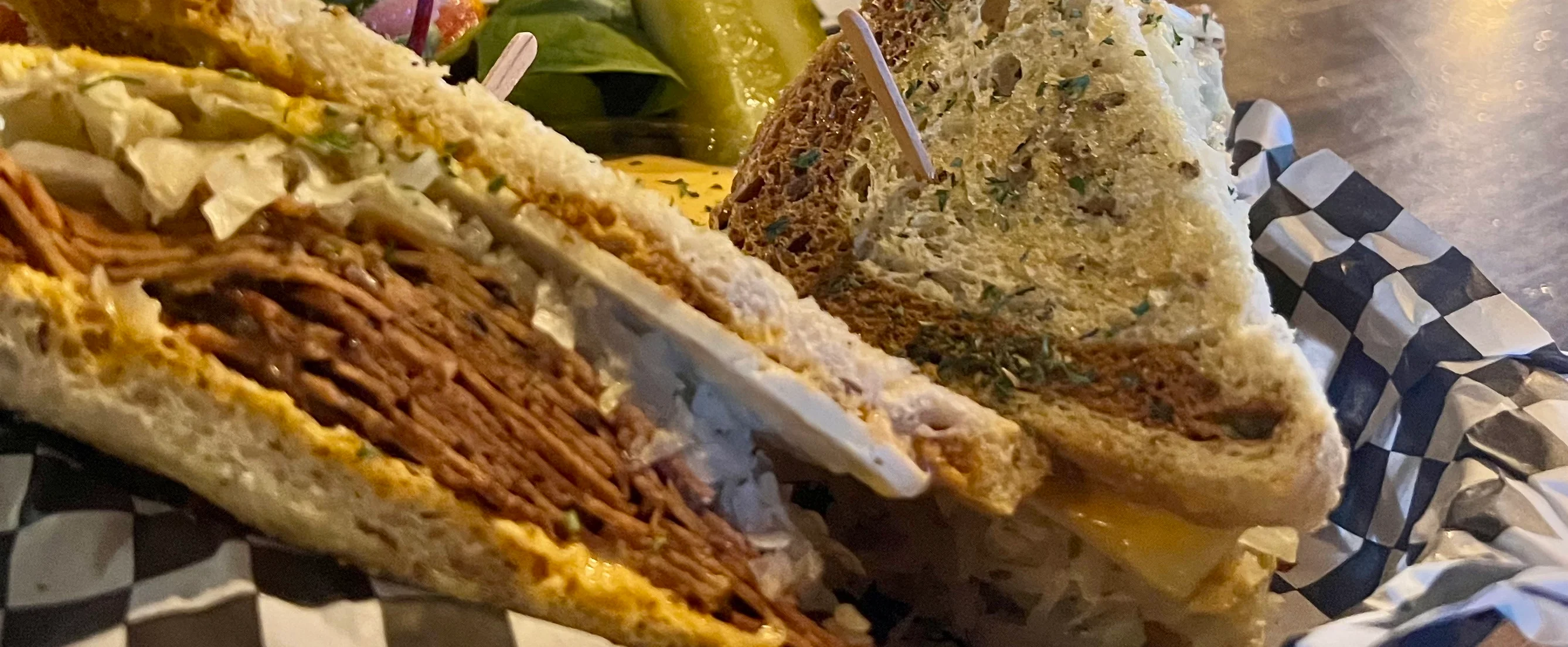 A delicious Reuben sandwich with corned beef, sauerkraut, and melted cheese.
