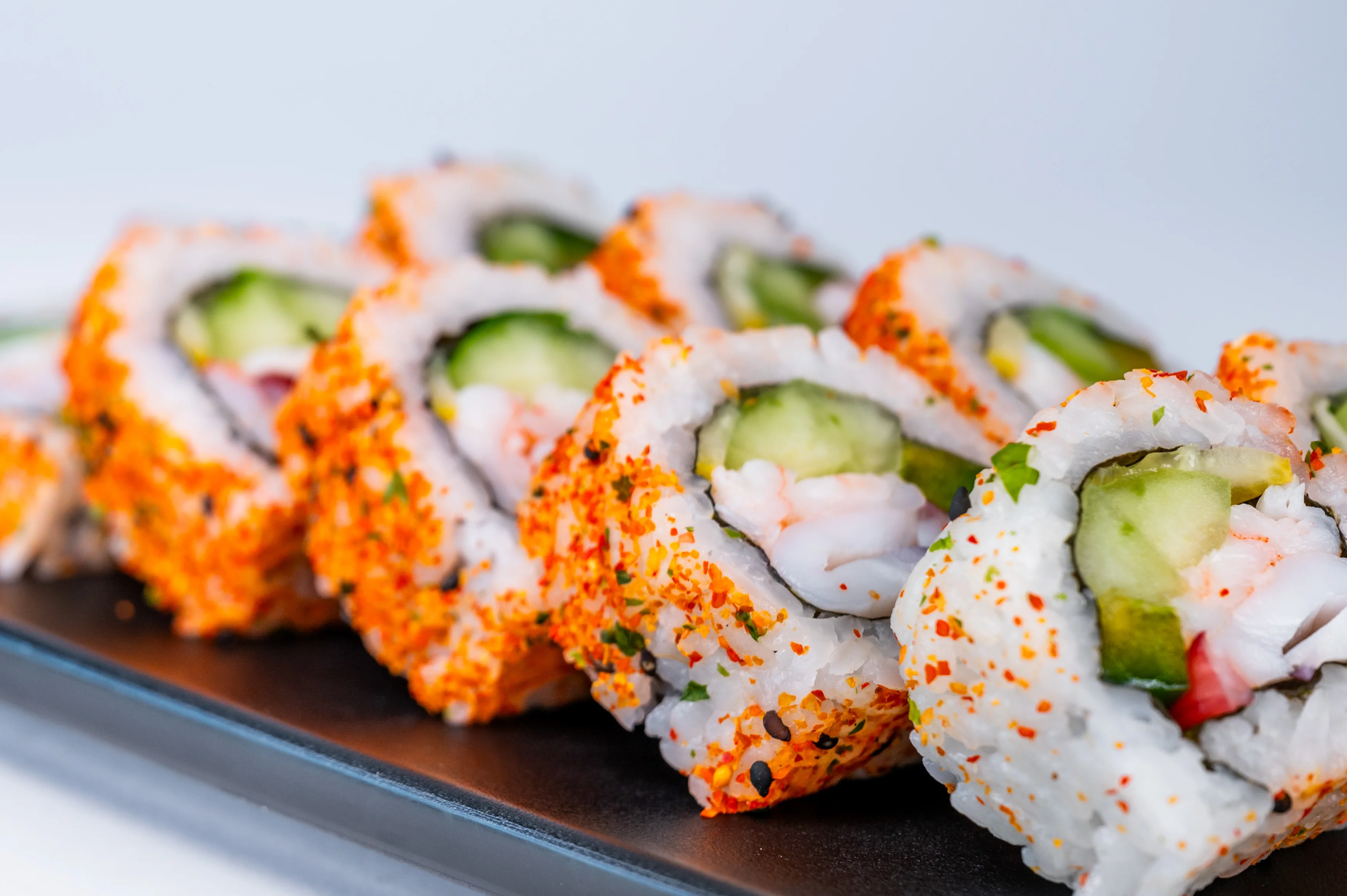 Colorful sushi rolls with shrimp and cucumber