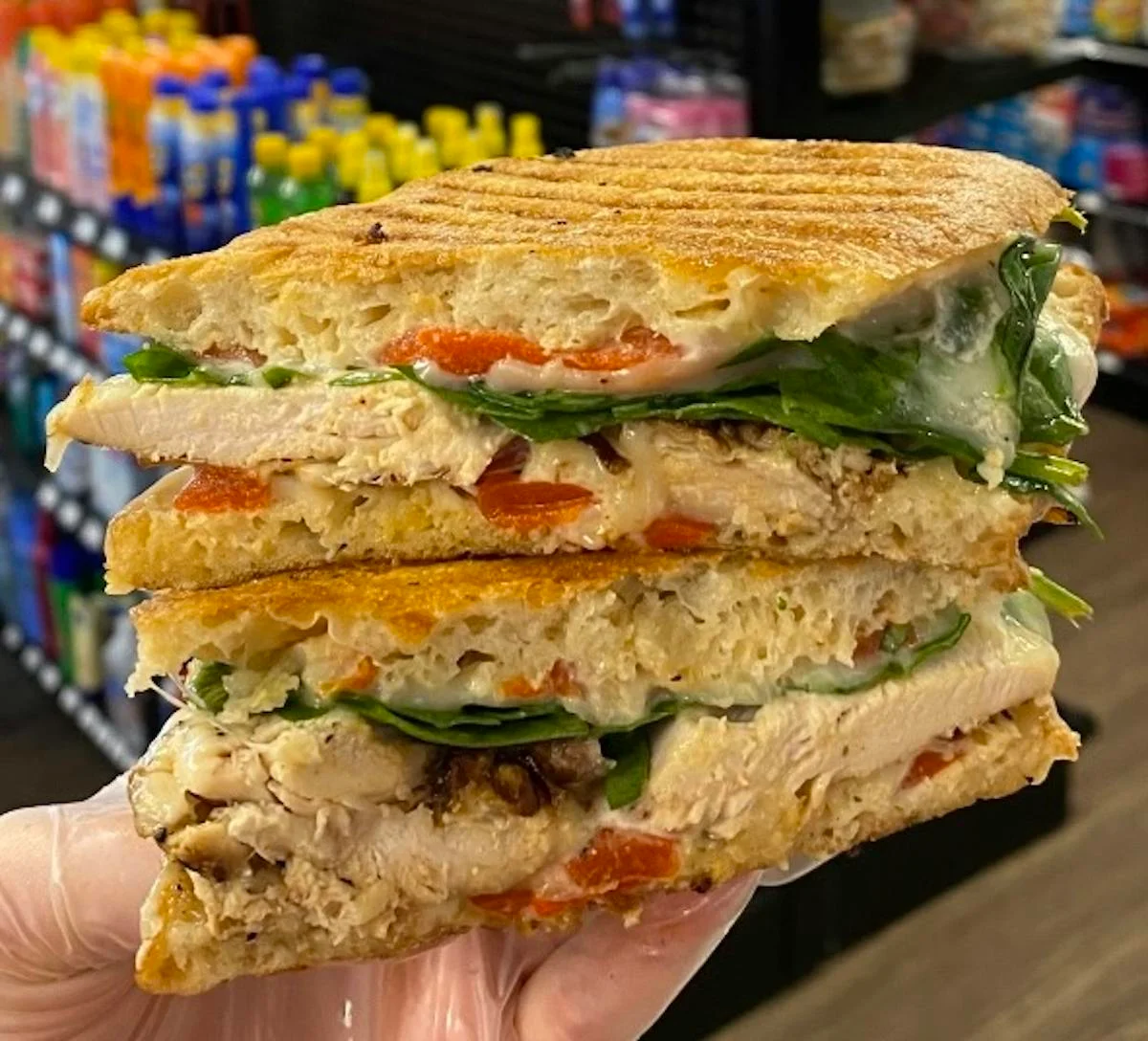 Grilled chicken panini with spinach and roasted peppers