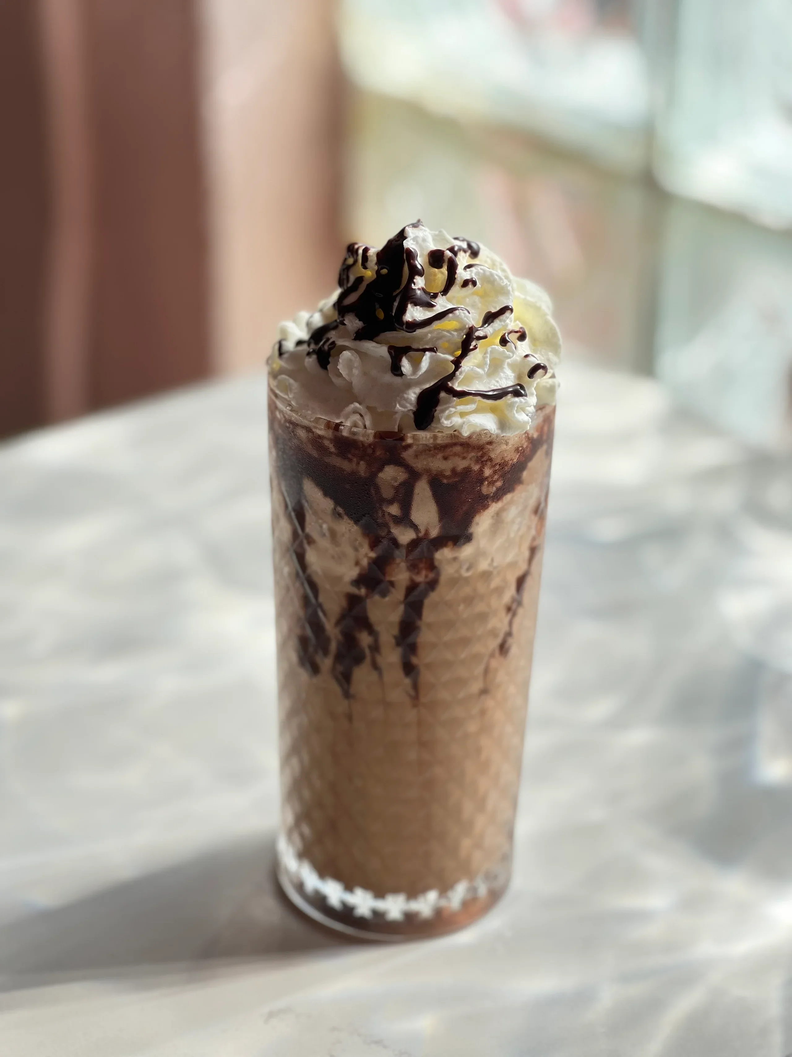 Decadent chocolate milkshake topped with whipped cream