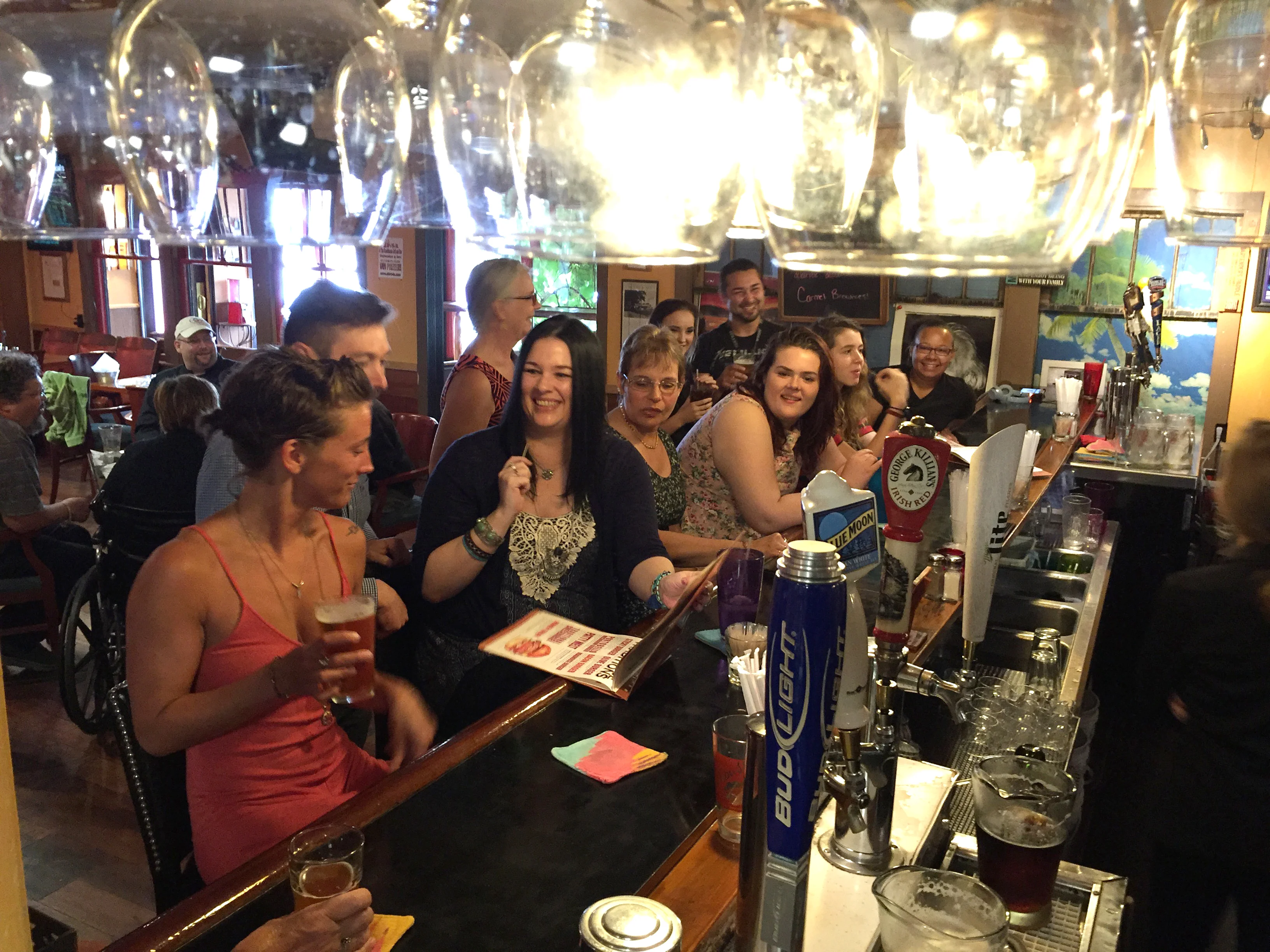 Lively bar scene with patrons enjoying drinks and conversation