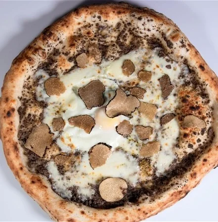Truffle pizza with creamy egg and black truffles