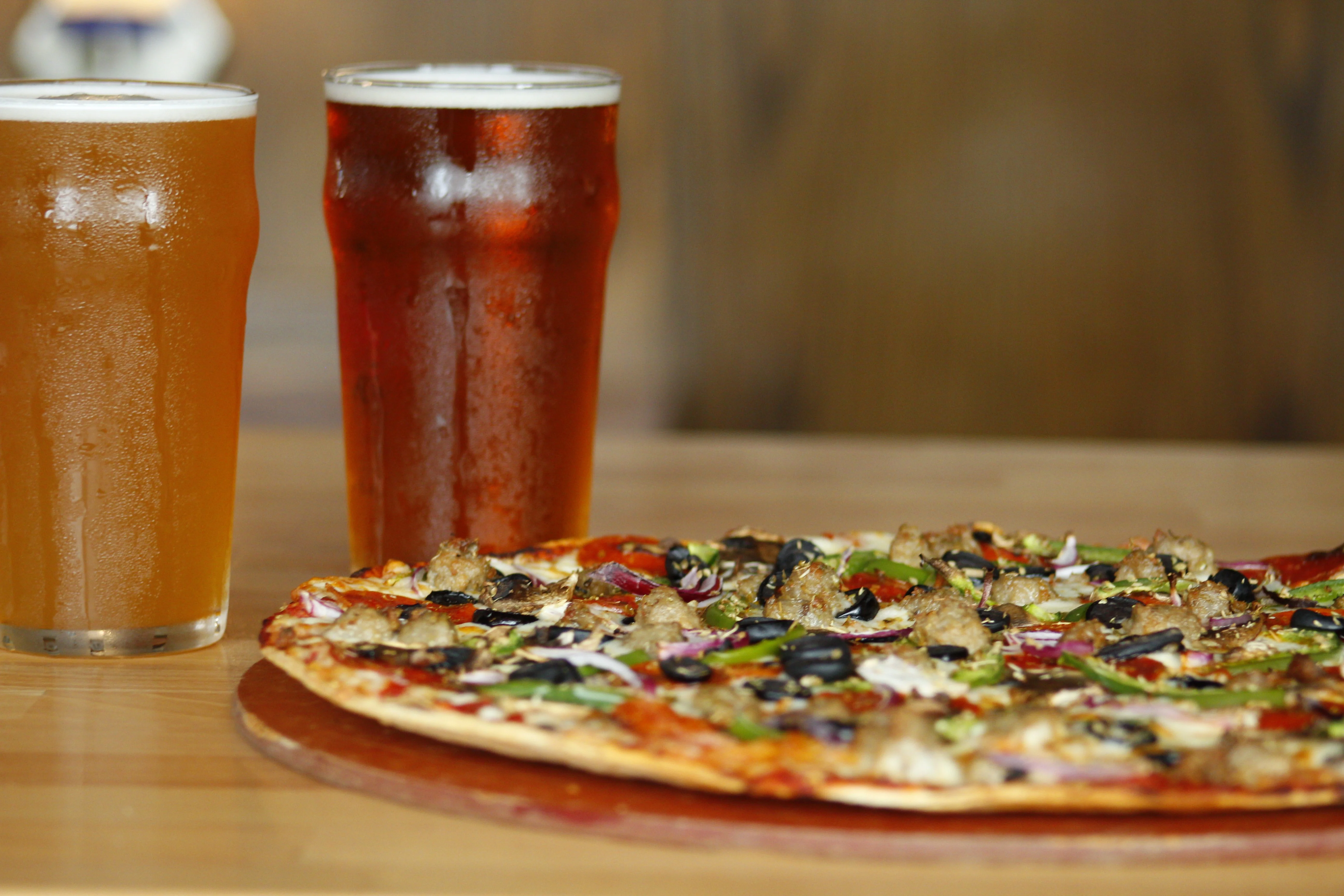 Delicious meat pizza paired with craft beers