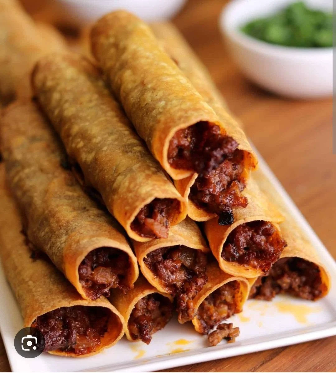 Crispy Mexican beef flautas served on a platter
