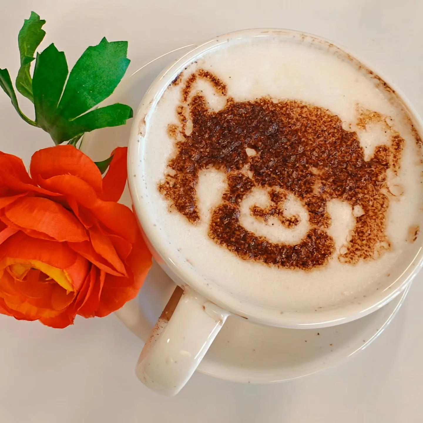 Artistic latte with bear design and a flower garnish
