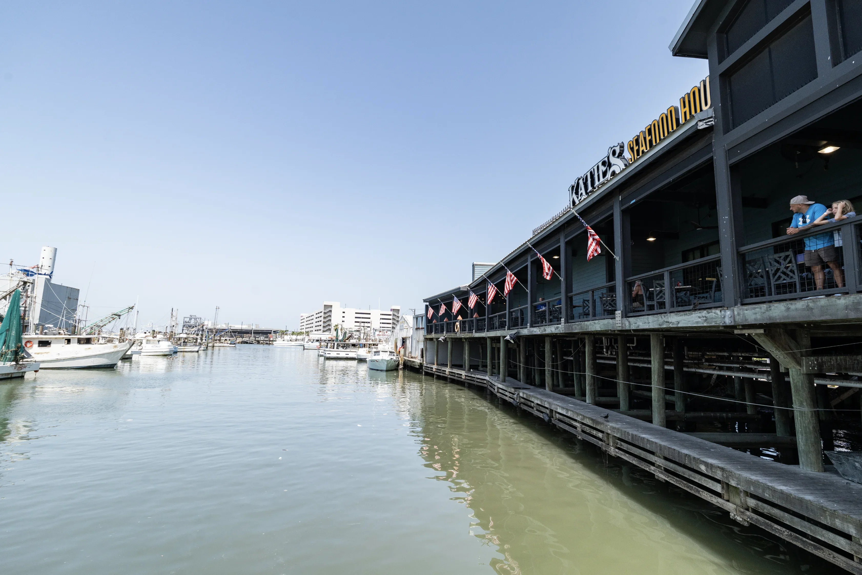 Katie's Seafood House by the water with a boat docked