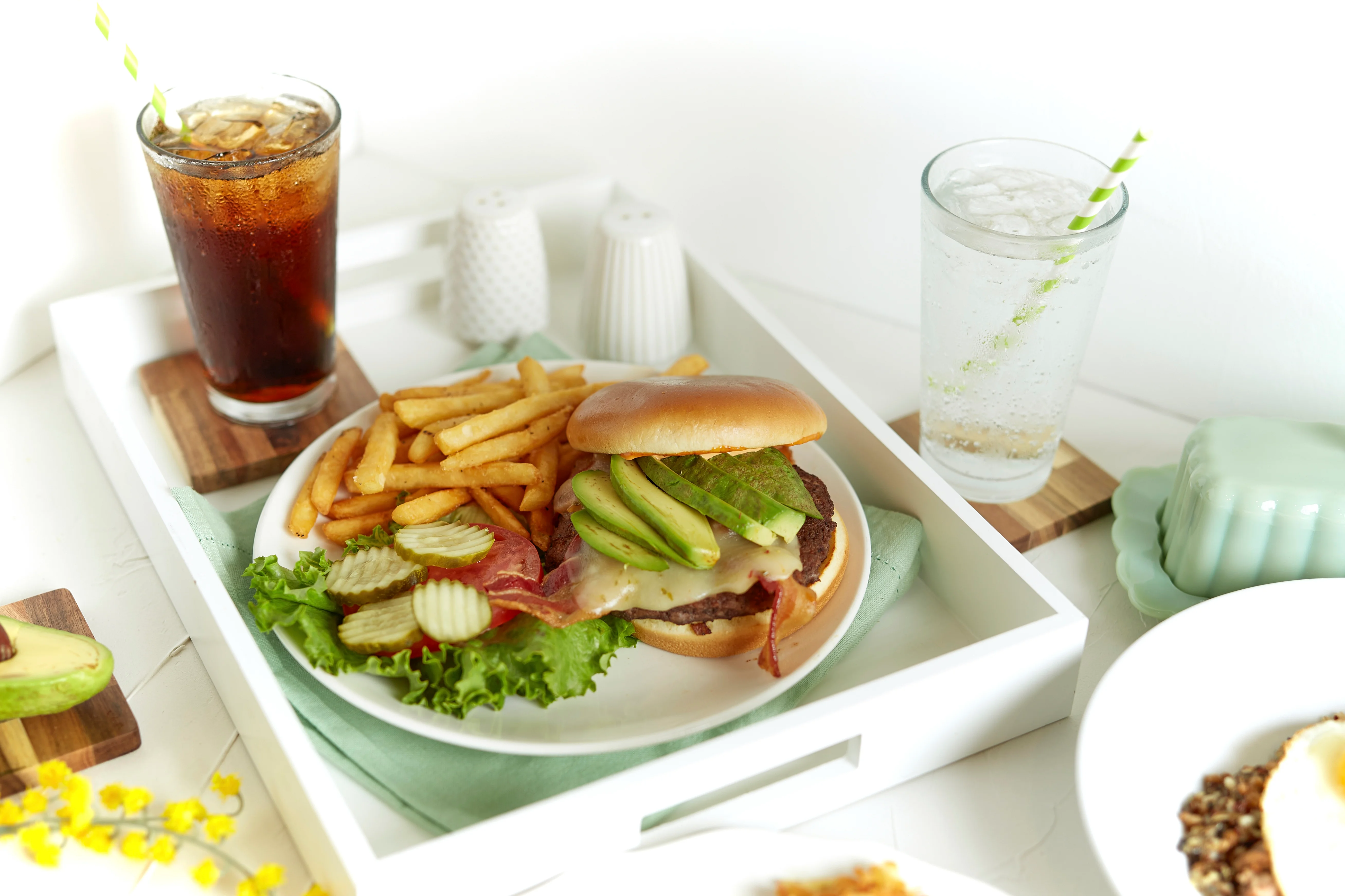 Classic American cheeseburger with fries and drinks
