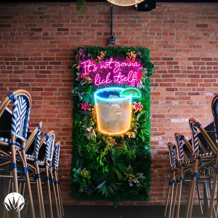 Colorful neon sign in a trendy restaurant with tropical decor