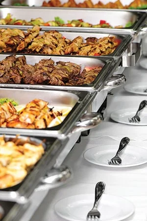 Buffet spread featuring grilled meats and vegetables