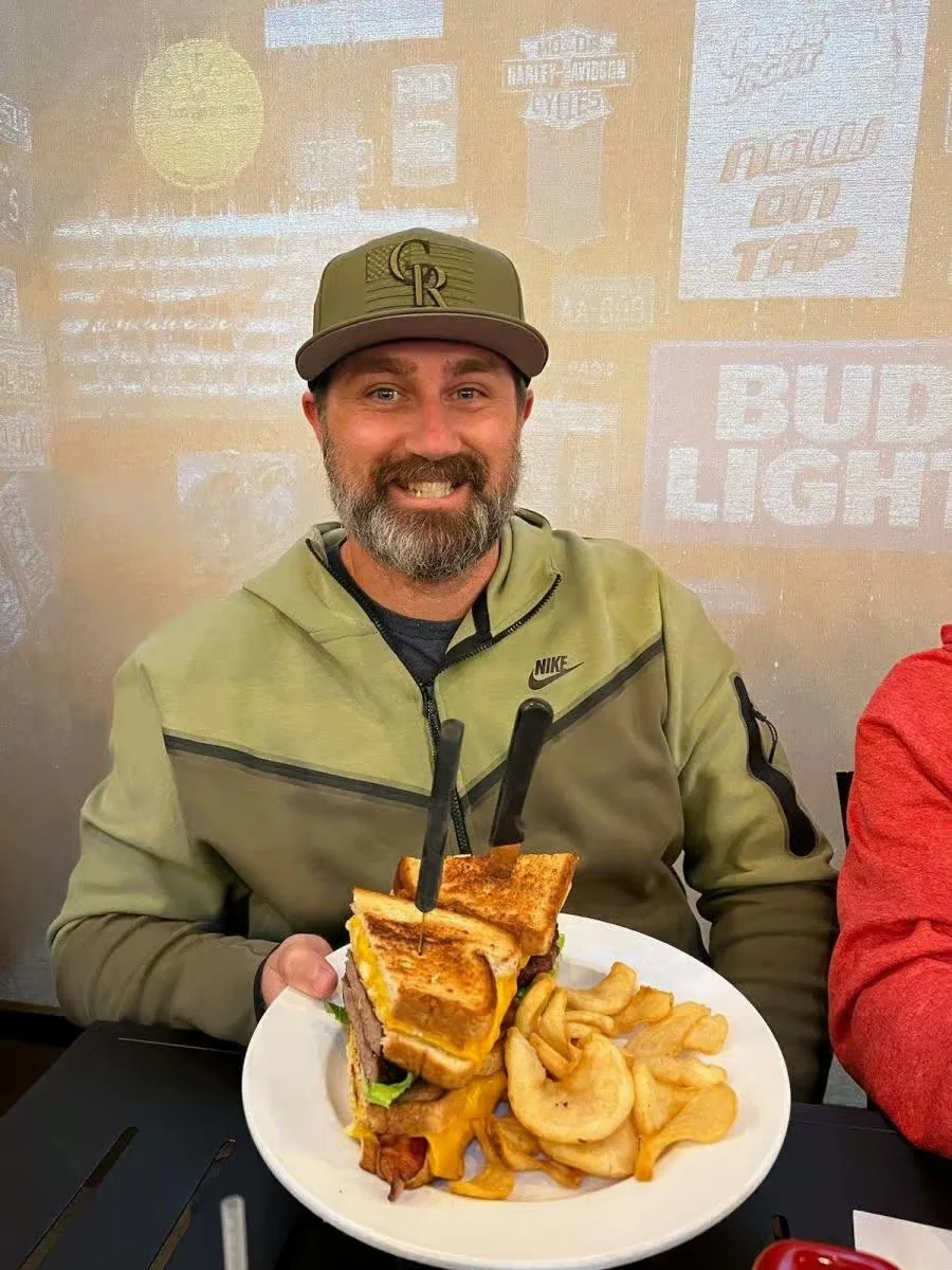 Giant cheeseburger with fries in a casual dining setting