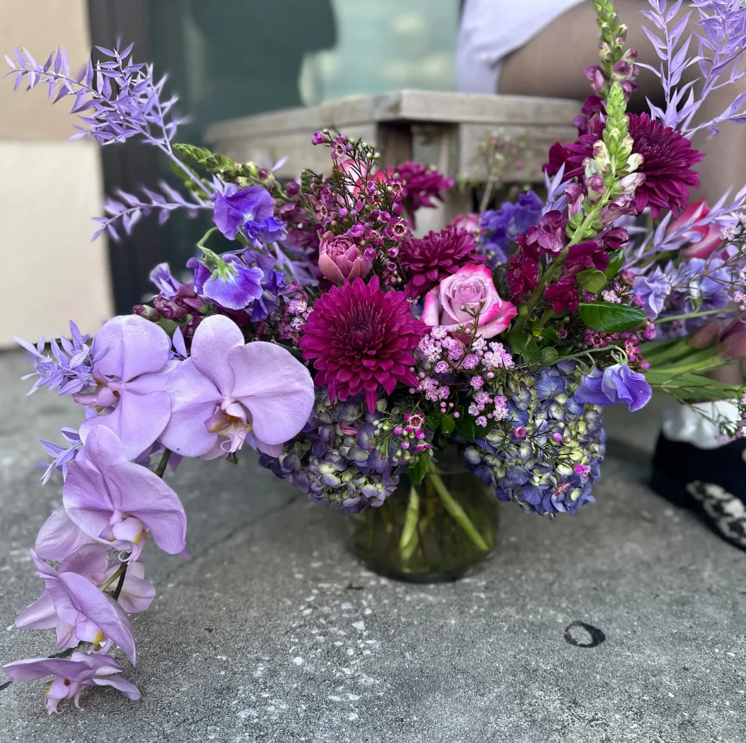 Vibrant floral arrangement with purple orchids and mixed blooms