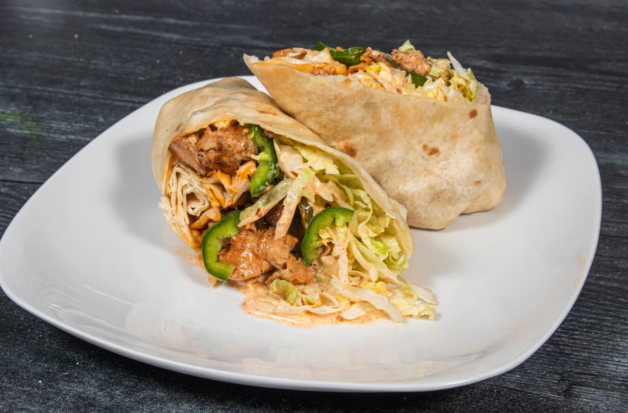 A delicious spicy wrap filled with fresh ingredients and vibrant colors.