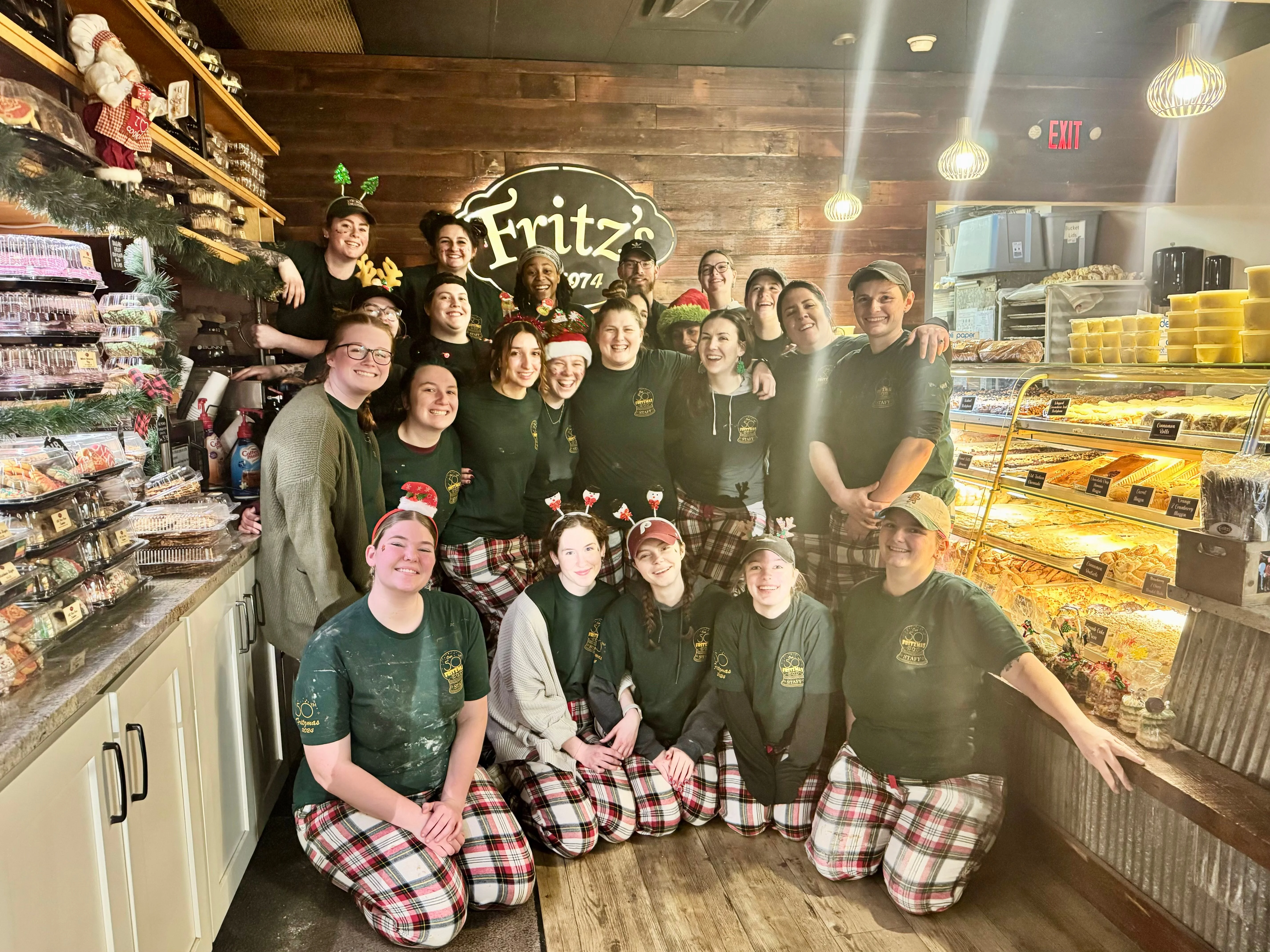 Festive team photo at a cozy bakery with holiday decorations