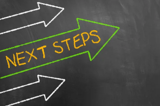 Chalkboard with arrows and text 'Next Steps'