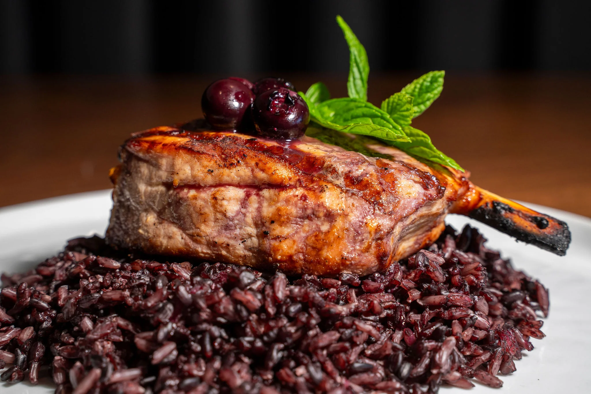 Grilled pork chop with black rice and berries