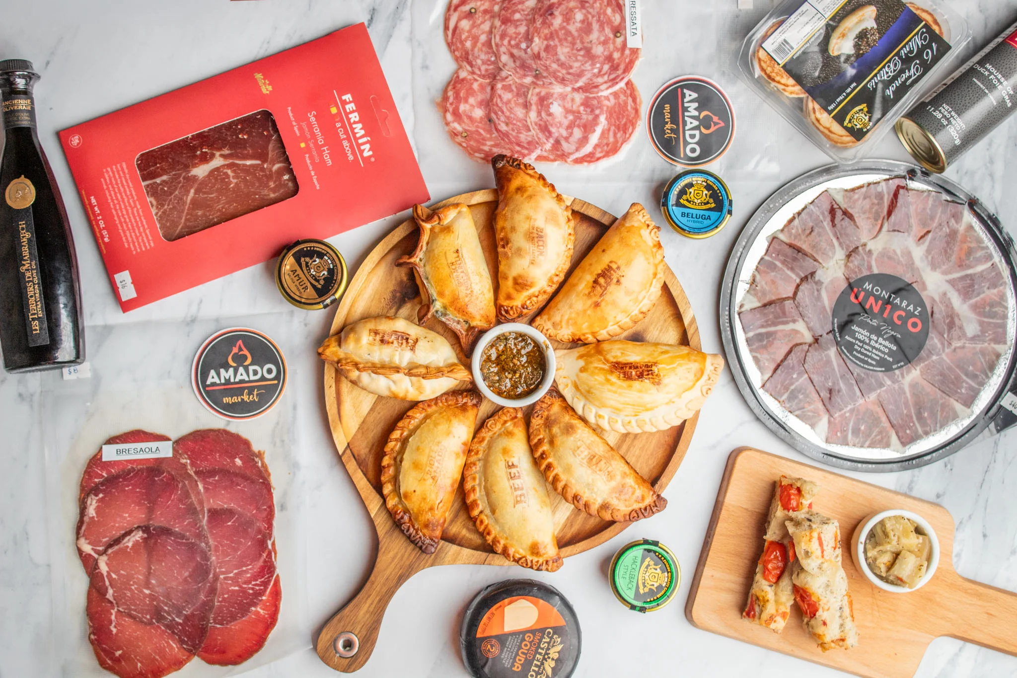 Argentinian empanadas with assorted cured meats and condiments