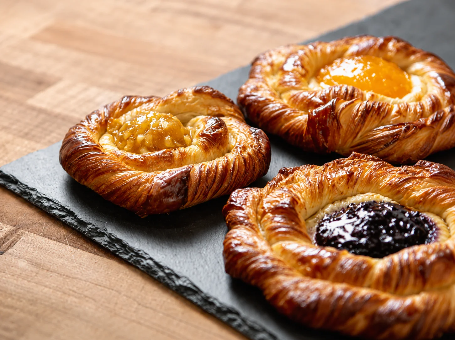 A selection of beautifully arranged pastries on a display.