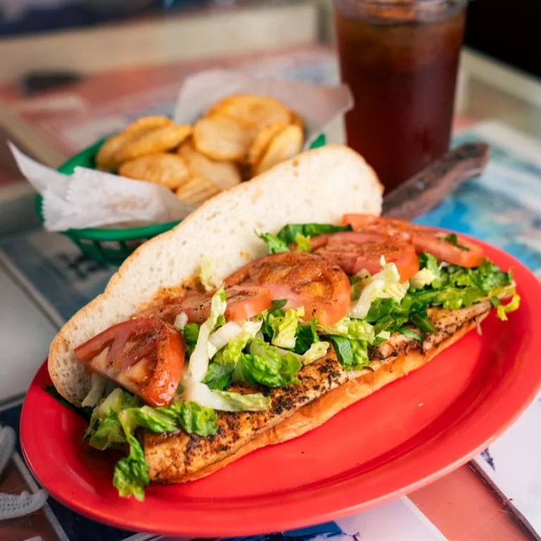 Grilled fish sandwich with fresh lettuce and tomatoes
