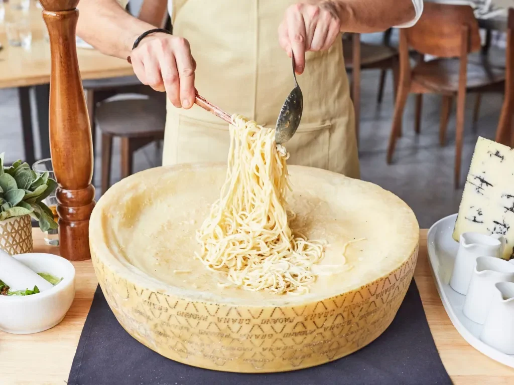 Pasta served in a cheese wheel, a classic Italian dish