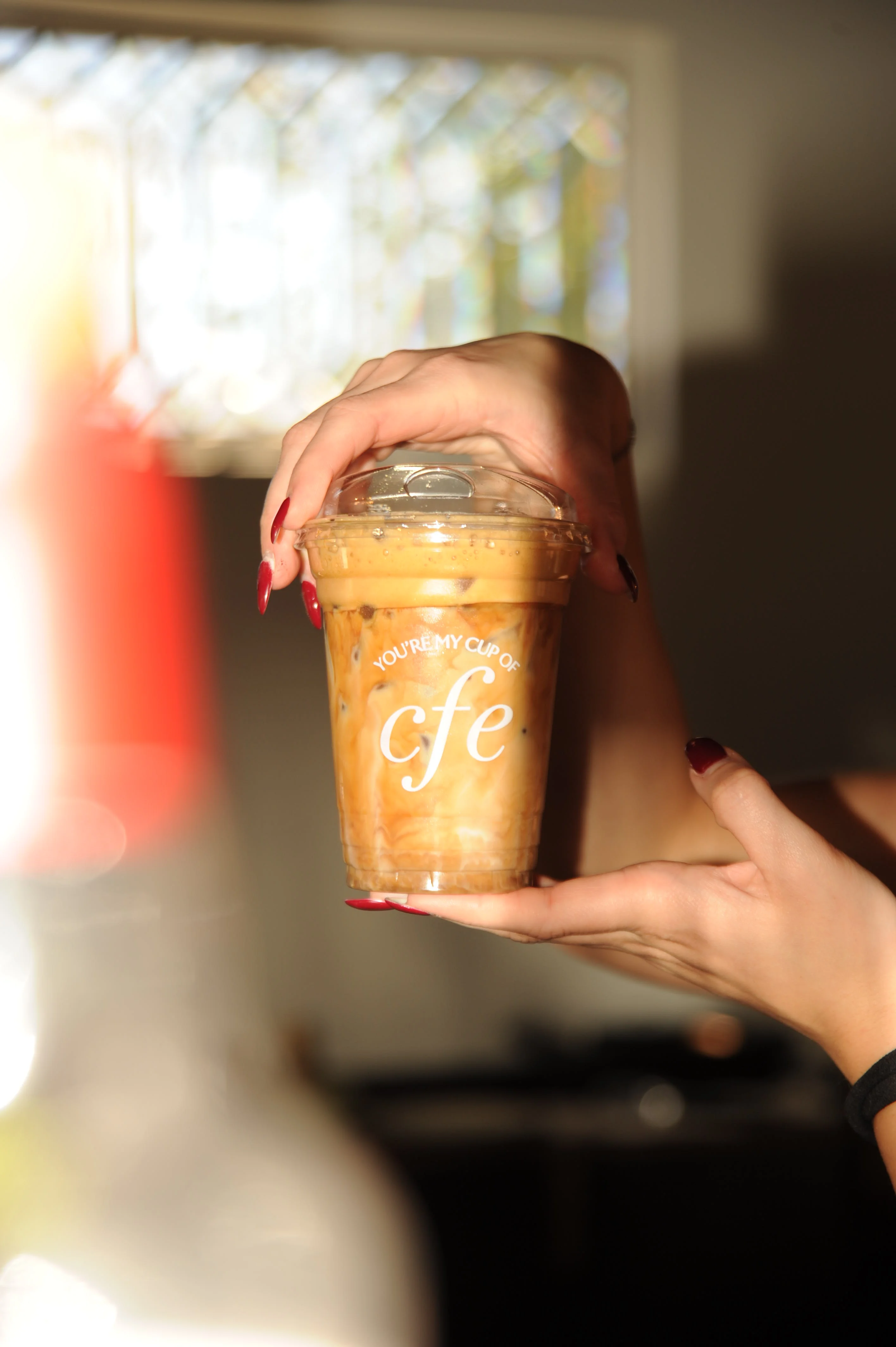 Iced coffee drink in a clear cup with a stylish design