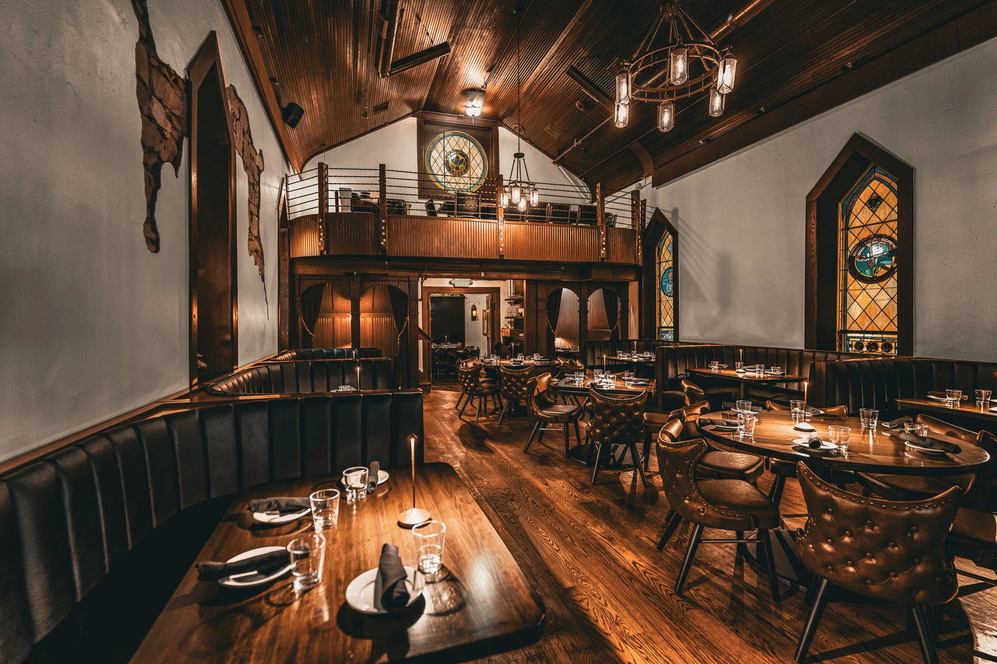 Elegant restaurant dining room with stained glass windows and warm lighting