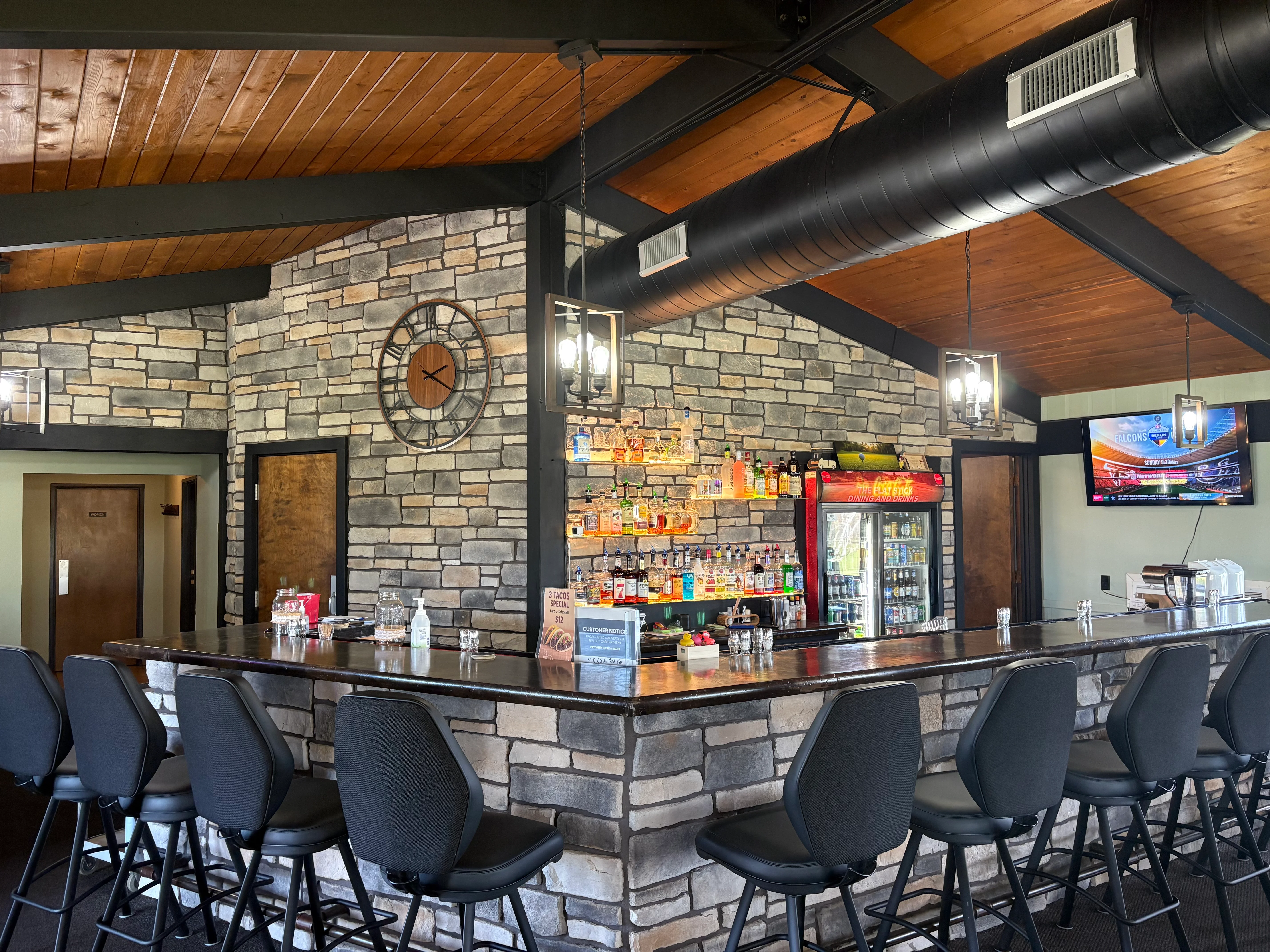 Modern bar interior with stone walls and stylish seating