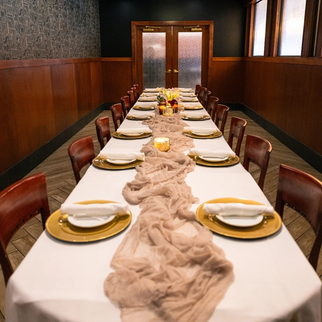 Private dining room with elegantly set table at Bass Street in downtown Moline, IL