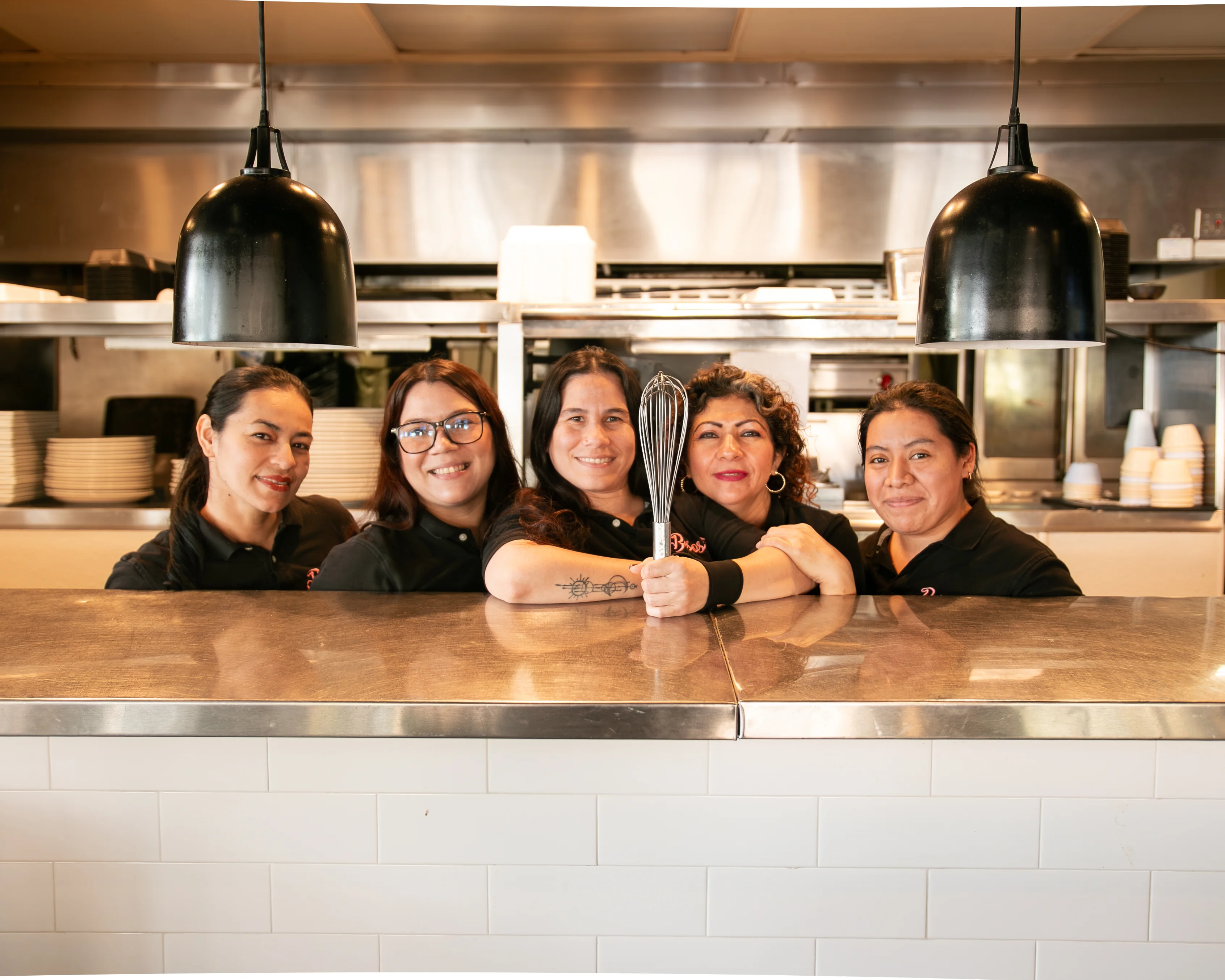 Culinary team posing in a vibrant restaurant kitchen