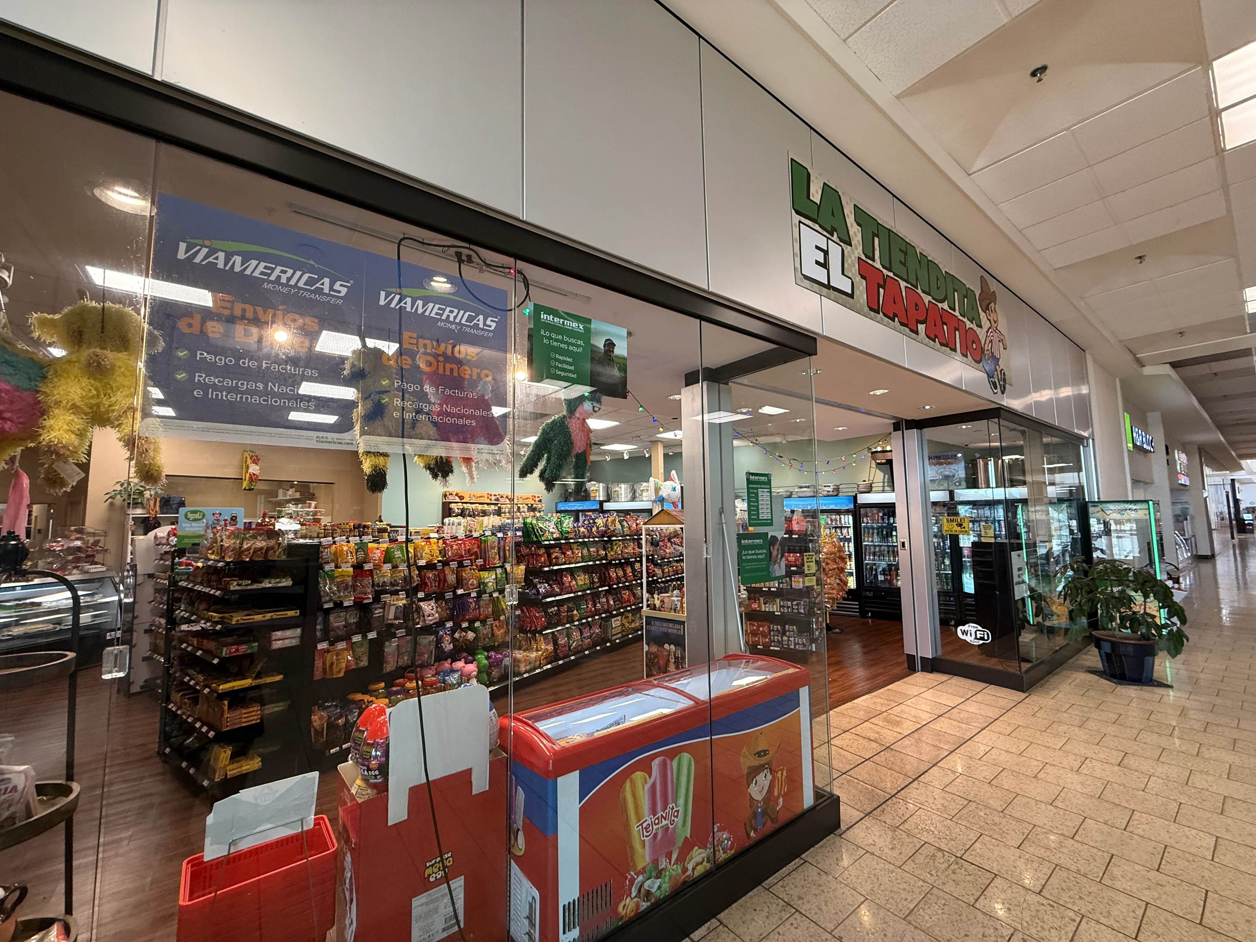 A variety of snack items neatly displayed on shelves in a store, including chips and candies in vibrant packaging.
