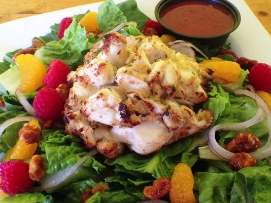 Grilled crab salad with mixed greens and citrus