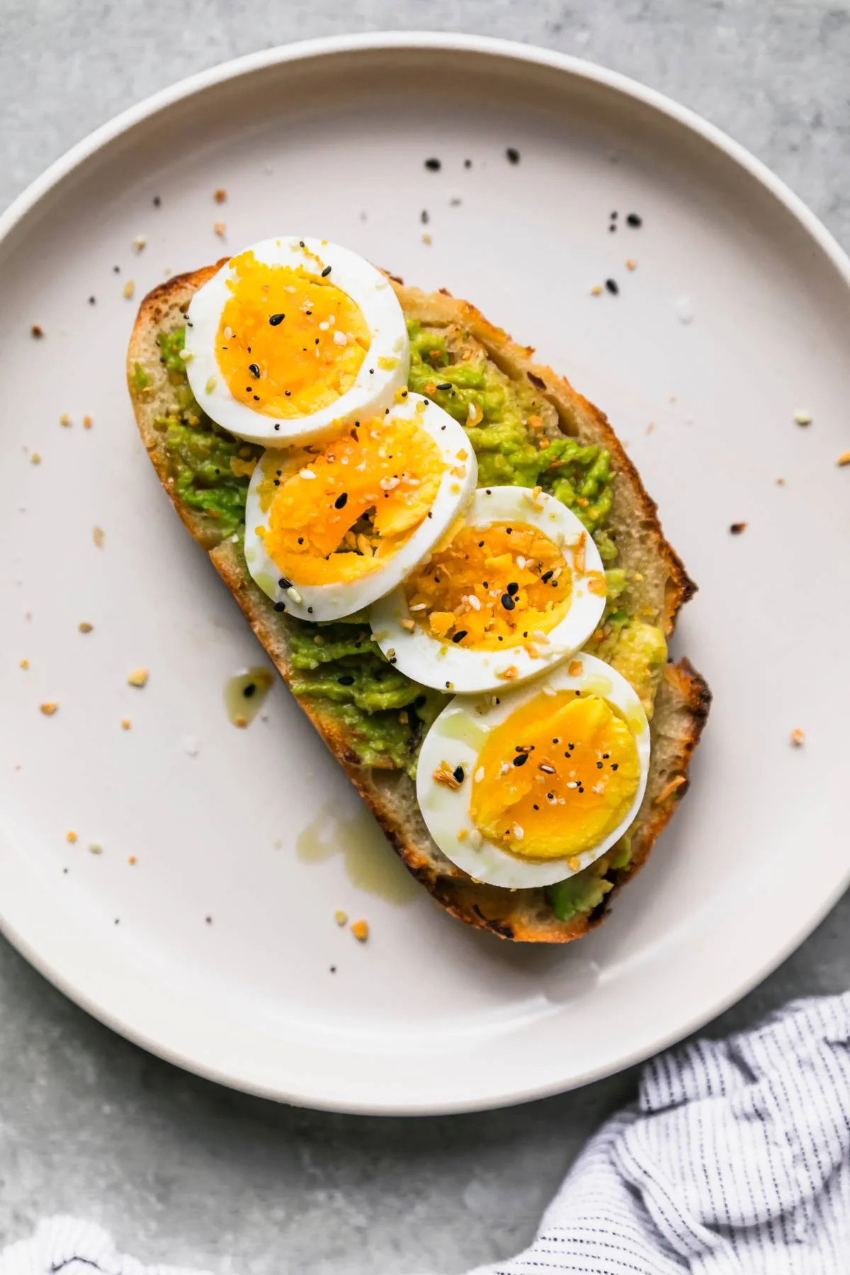 Avocado toast topped with soft-boiled eggs
