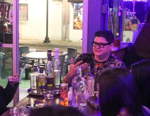 Social gathering at a bar with cocktails and lively conversation