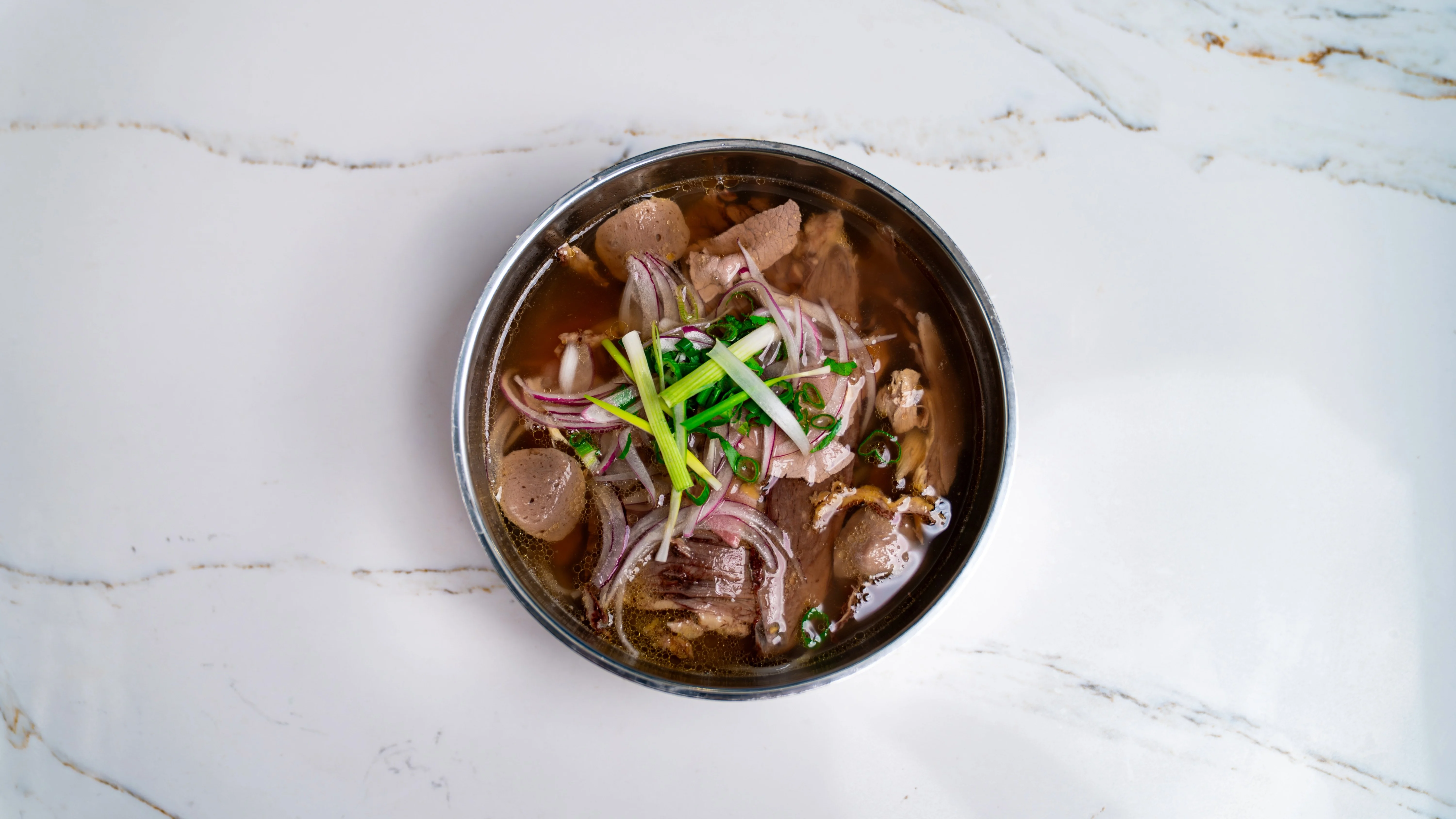 Bowl of Thai boat noodles with herbs and spices