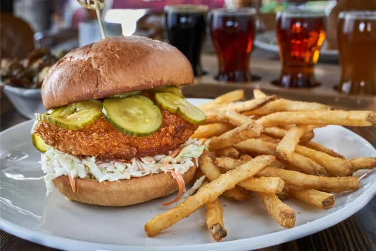 Southern fried chicken sandwich with pickles and fries