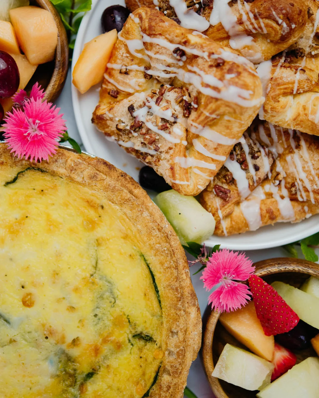 Savory quiche and sweet pastries on a brunch platter